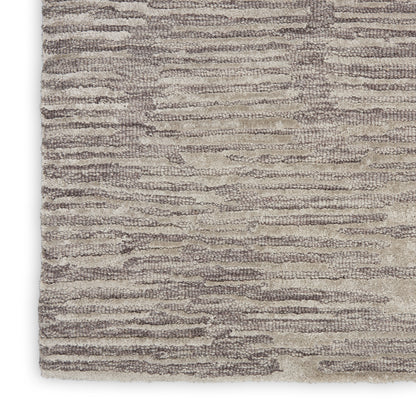 Beige and taupe textured area rug with soft plush pile and wavy linear pattern.