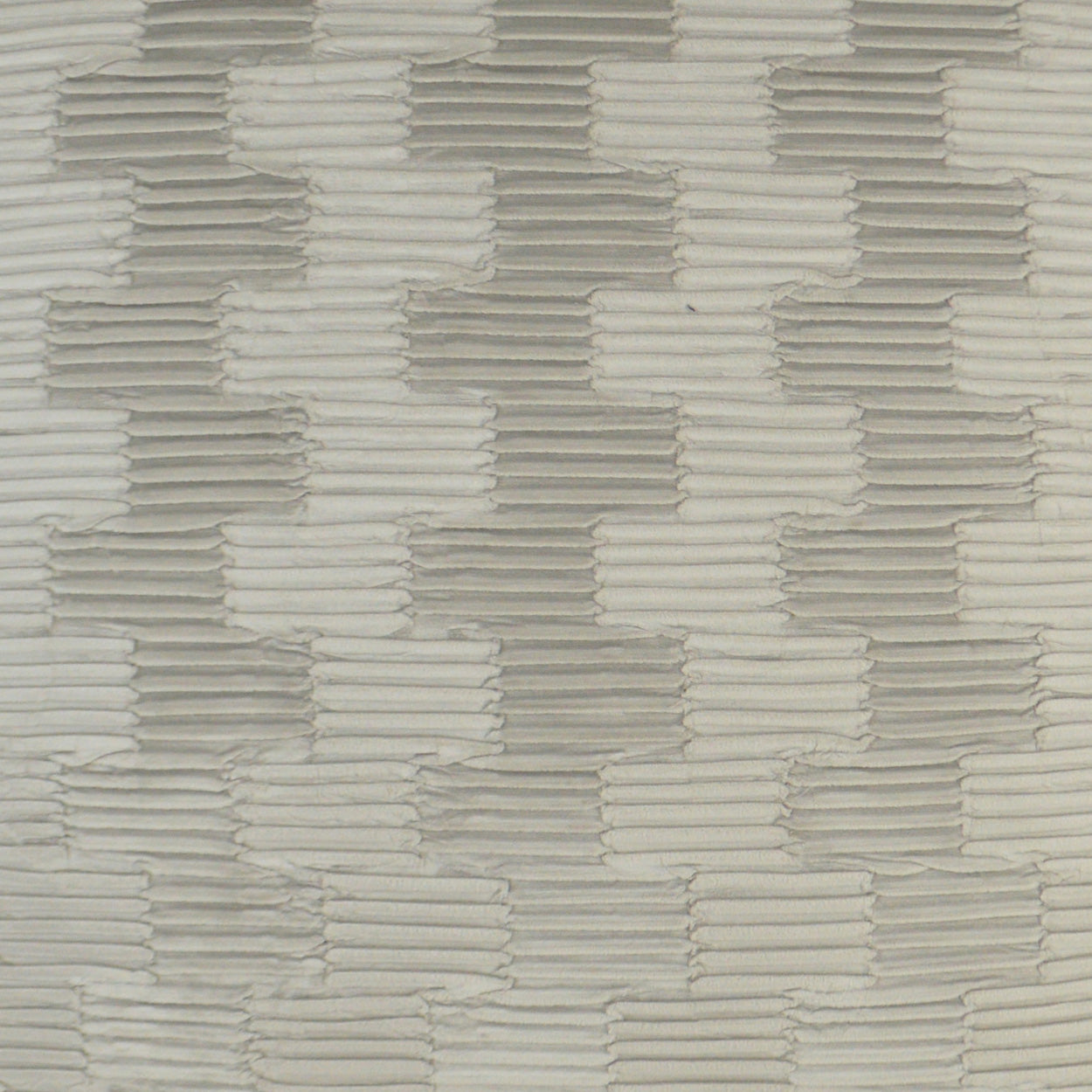 Beige and light gray textured woven fabric with a brick-like staggered pattern.