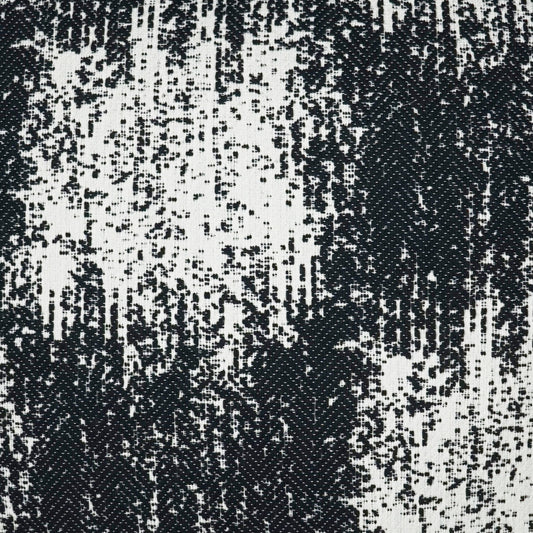 Close-up of black and white woven fabric with irregular vertical pattern; textured textile for upholstery or apparel.