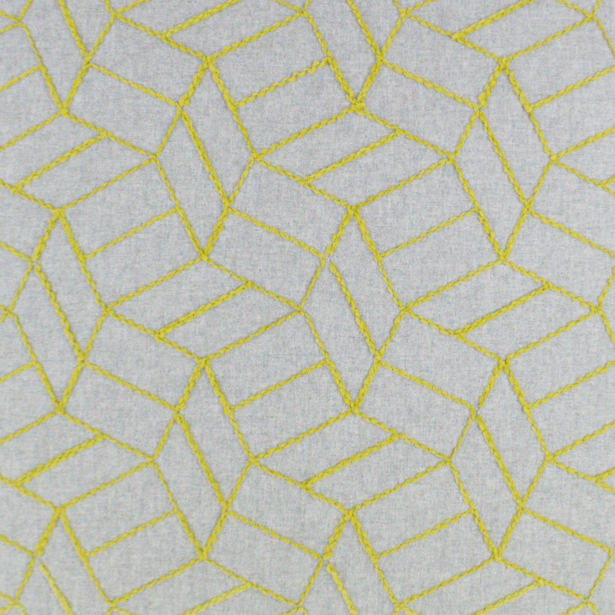 Gray fabric with bright yellow stitched geometric pattern of irregular polygons; modern decorative textile.