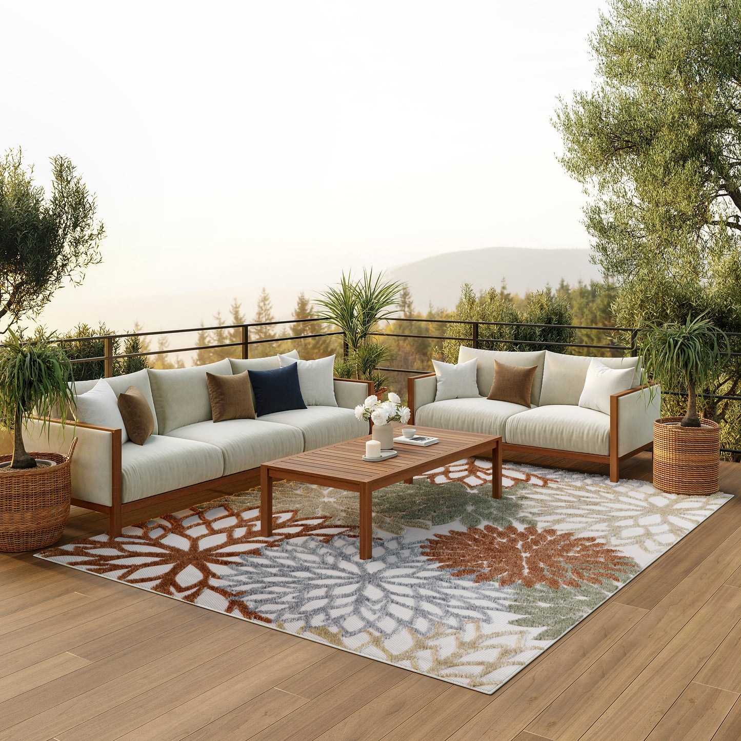 Outdoor sectional sofa set with beige cushions, wooden frame, colorful floral-patterned rug, wooden coffee table, potted plants on a deck.