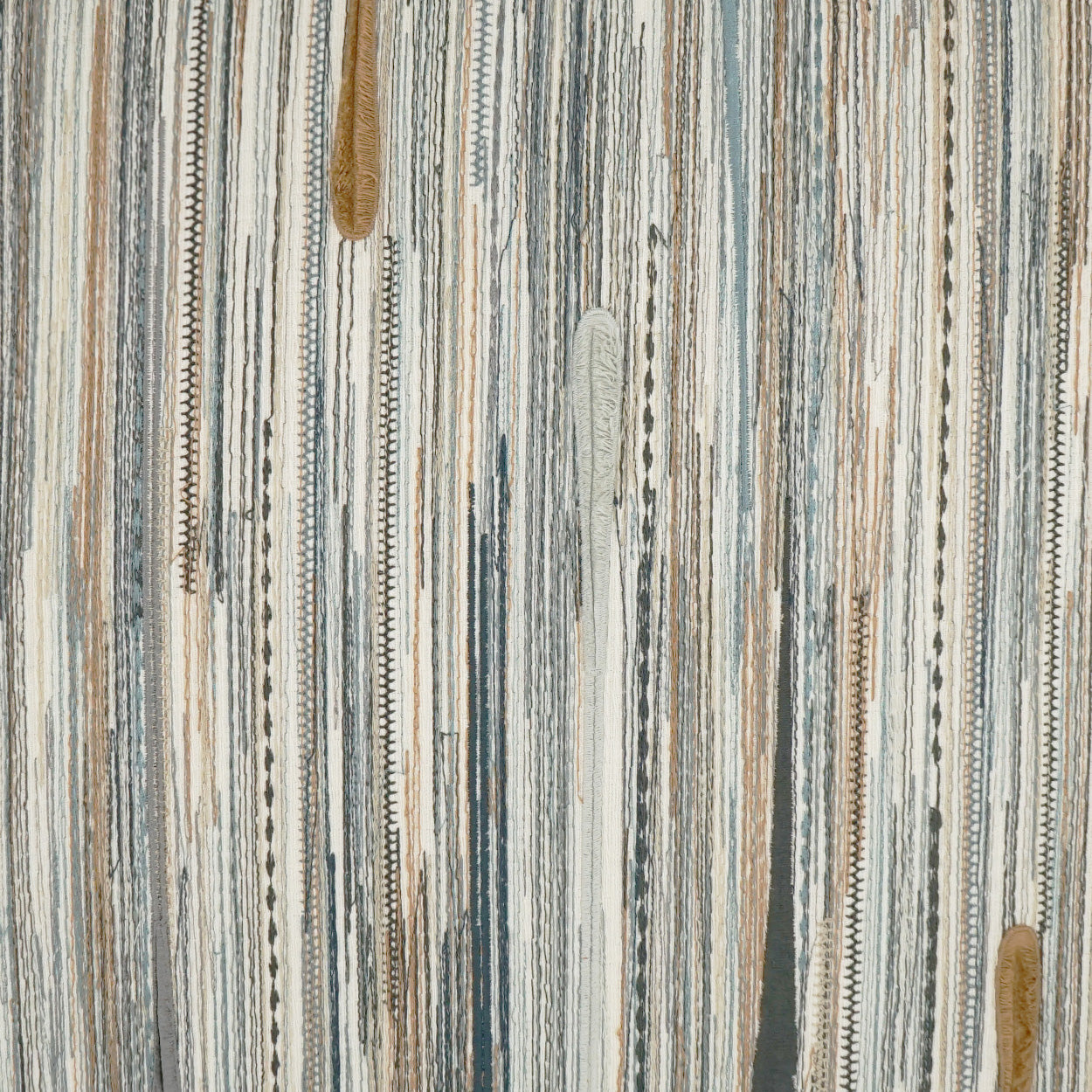 Vertical striped woven fabric in blue, gray and beige tones; textured upholstery or rug material.