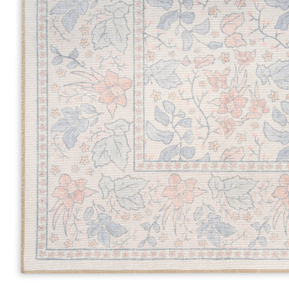 Pastel floral area rug with beige base, blue and peach flowers, and decorative border; woven texture.