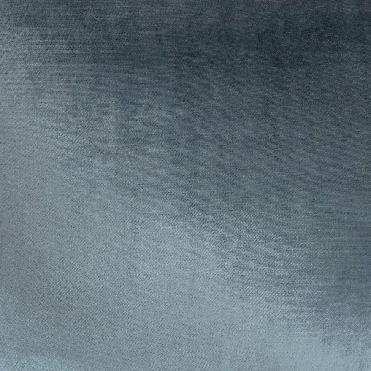Blue gradient velvet-like fabric texture, dark navy at top fading to light blue, soft woven surface.