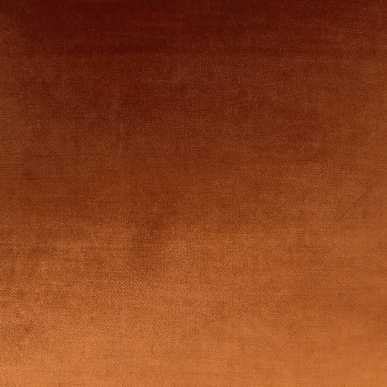 Close-up of warm orange-brown fabric texture with a soft weave.