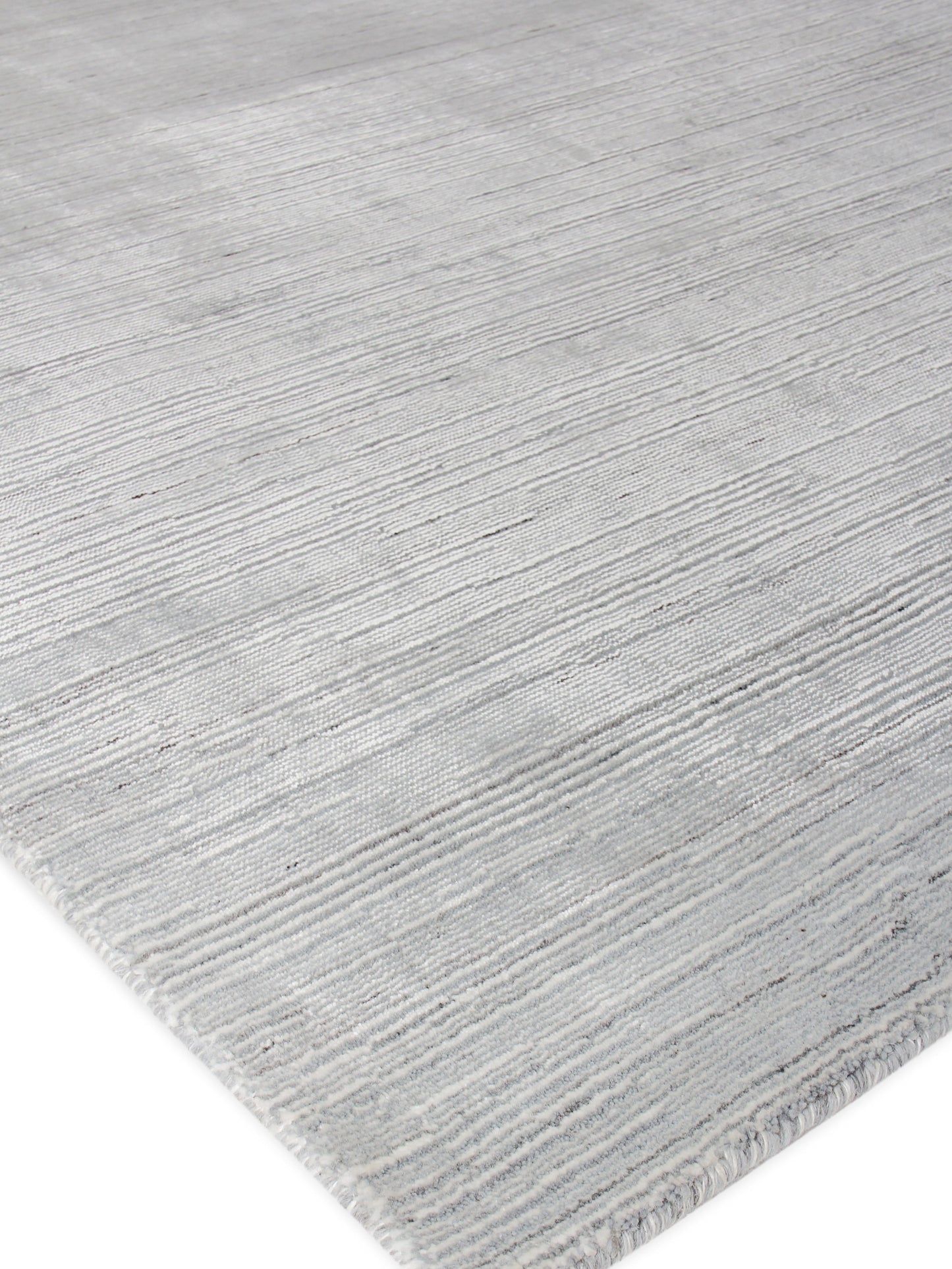 Soft gray striped area rug with a textured low pile and subtle linear pattern; edge visible.