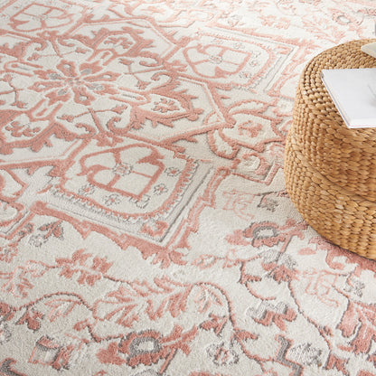 Pink & cream oriental rug with intricate motifs.
