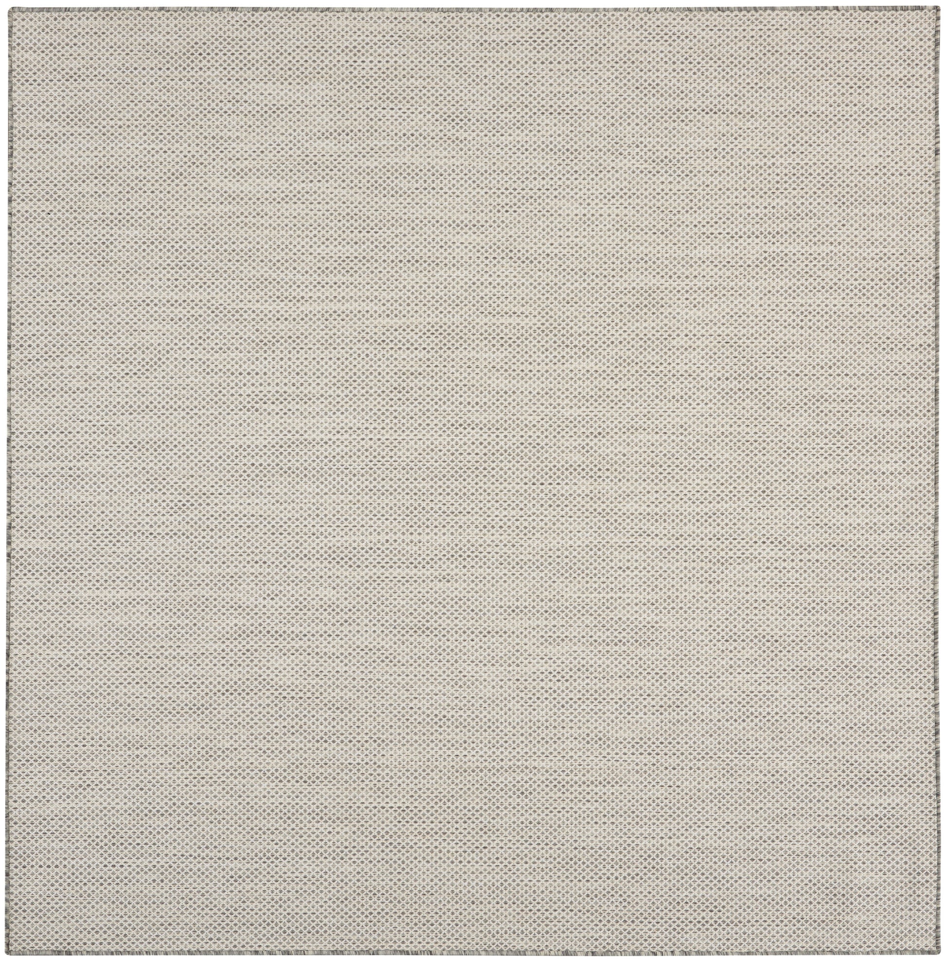 Beige rug with tiny grey dotted pattern, square shape, soft woven texture.