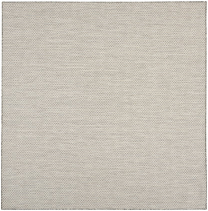 Beige rug with tiny grey dotted pattern, square shape, soft woven texture.