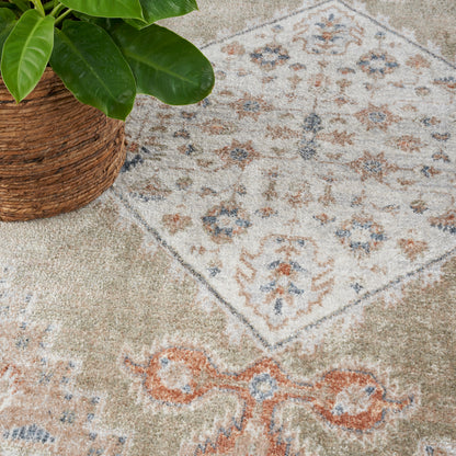 Vintage oriental-style beige rug with blue, rust and gray motifs, 7' x 9'.
