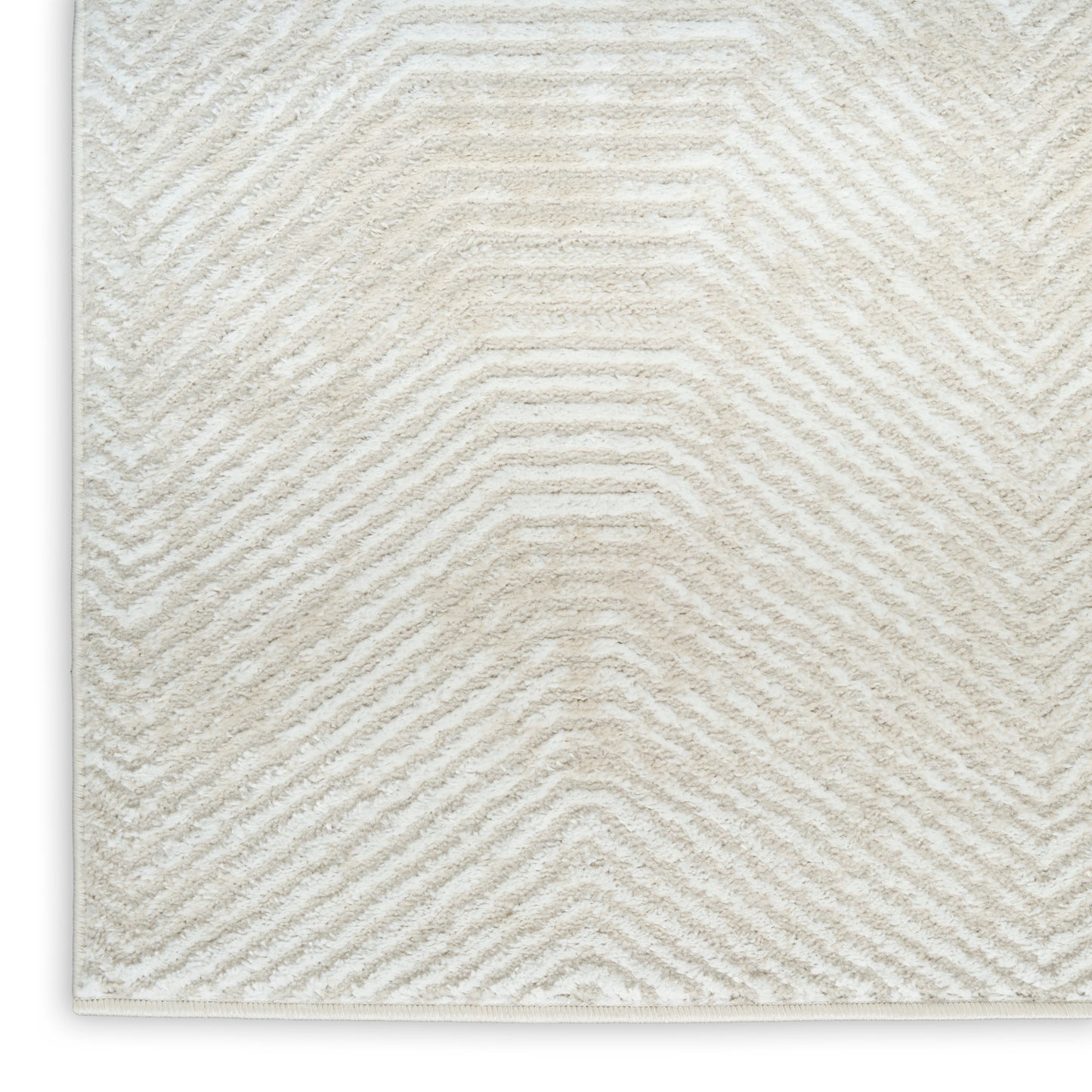 Cream textured rug with chevron zigzag pattern in beige and white, finished edge.