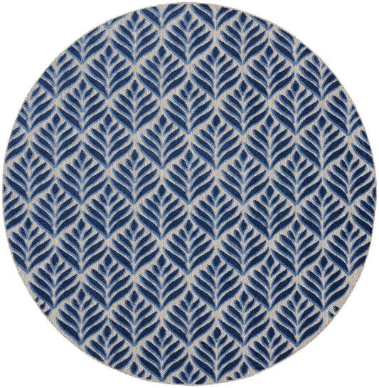 Round rug with navy blue leaf pattern on beige background; repeating botanical motif.