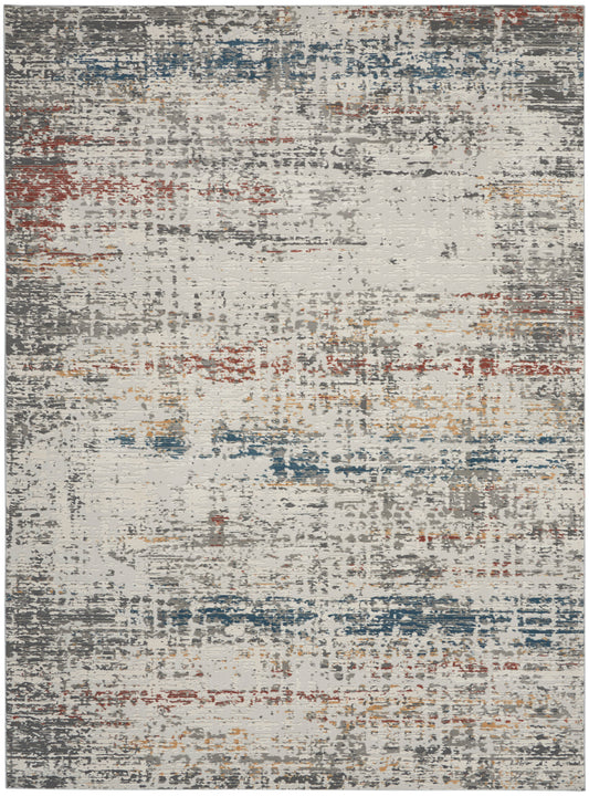 Abstract distressed area rug with gray base and blue, red, tan and orange accents; rectangular modern decor piece.