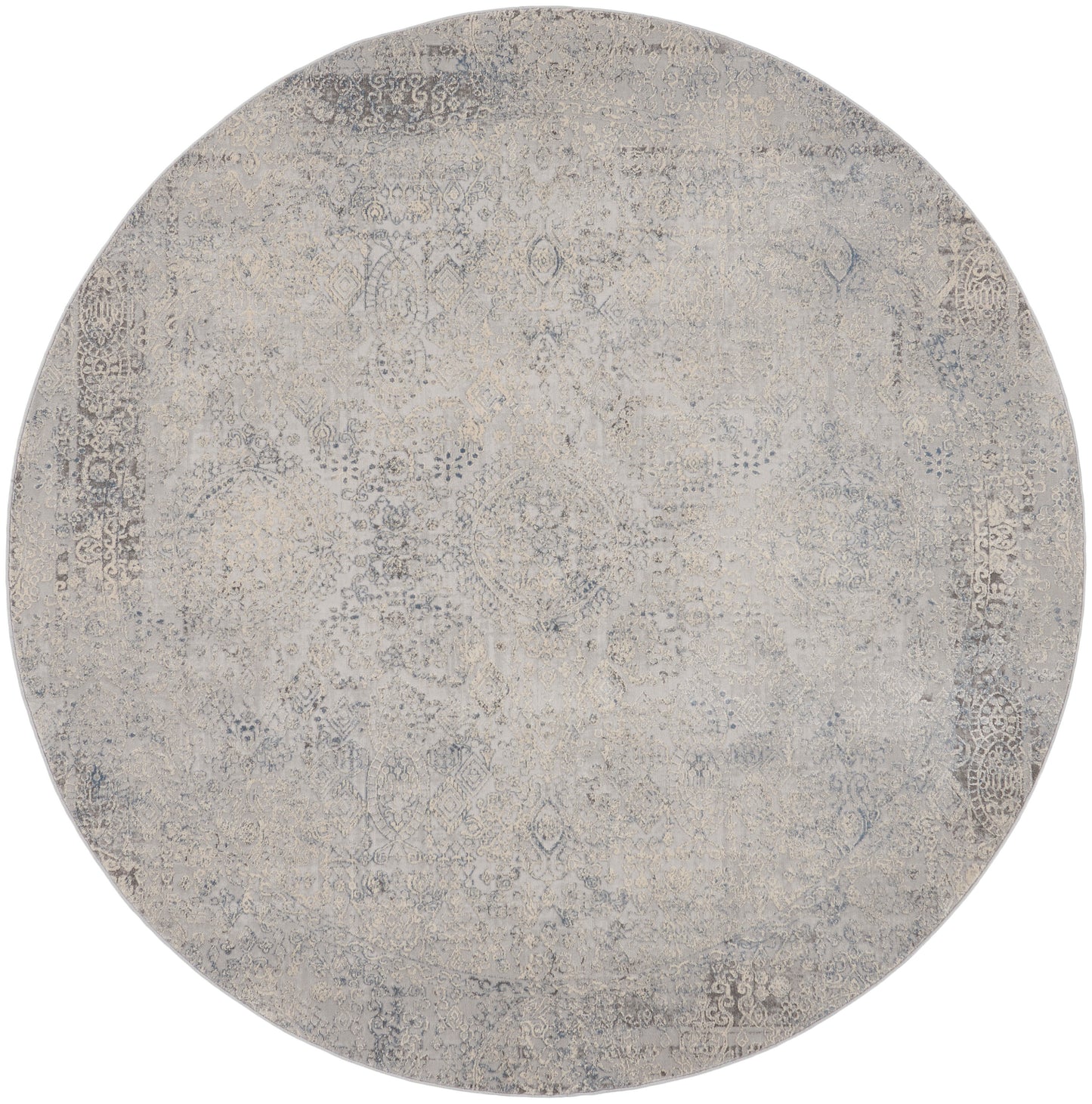 Round distressed rug in beige & gray tones with an ornate faded pattern; vintage Persian-inspired style.