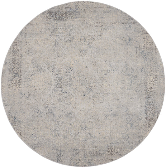 Round distressed rug in beige & gray tones with an ornate faded pattern; vintage Persian-inspired style.