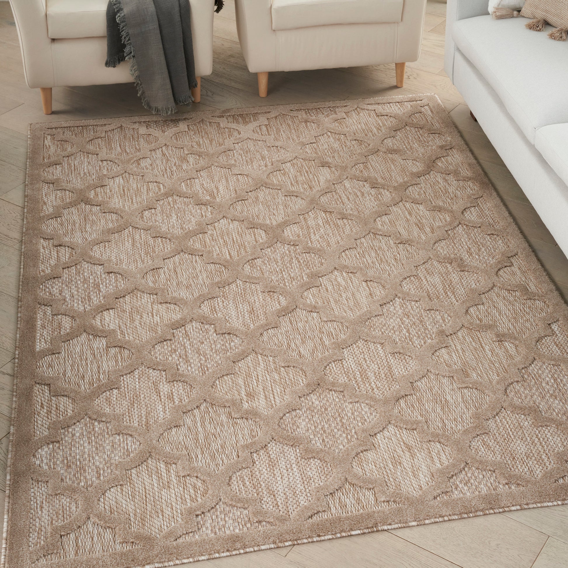 Beige woven area rug with taupe trellis pattern; textured, neutral living room style.