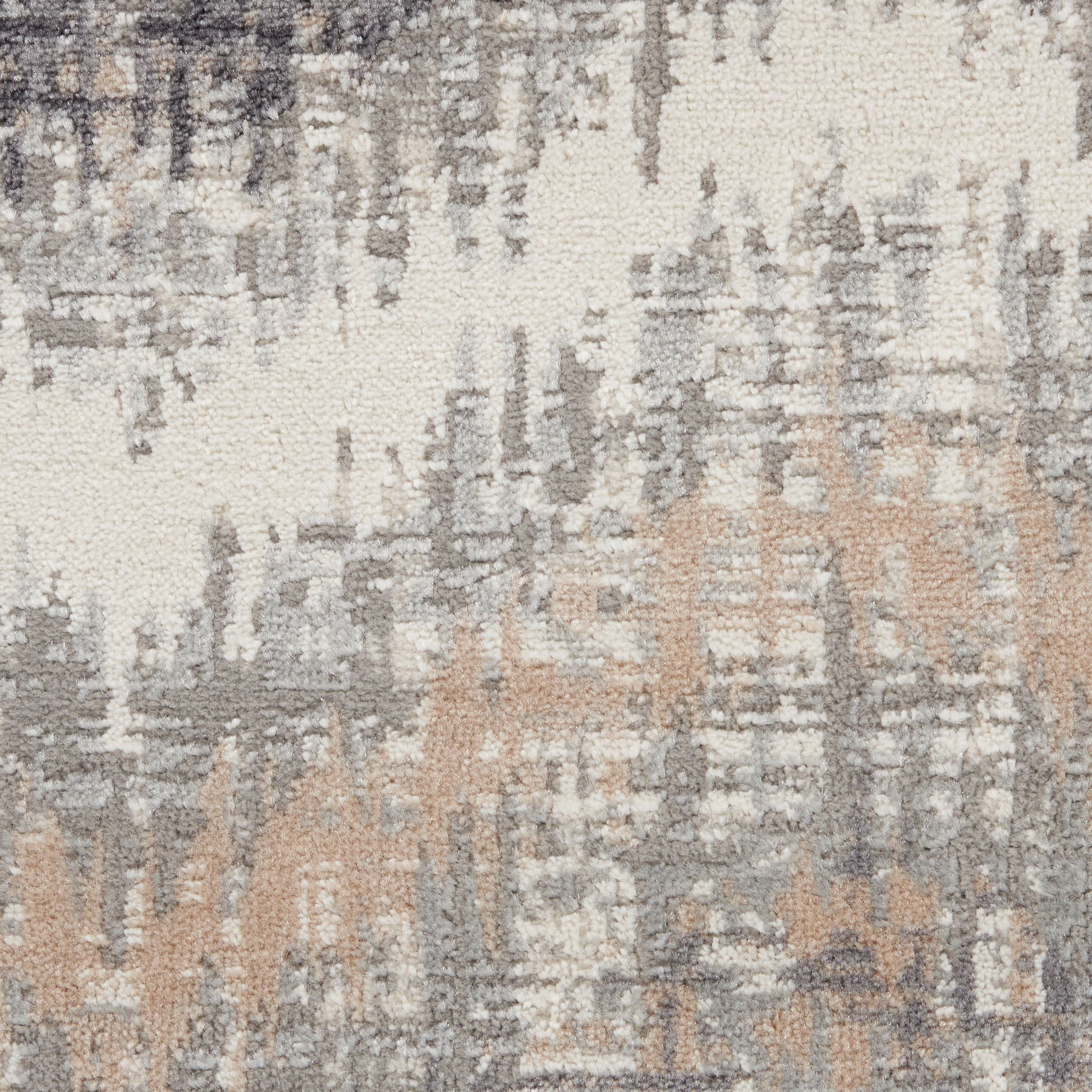 Abstract distressed area rug with cream, gray and beige tones and a brushstroke geometric pattern.