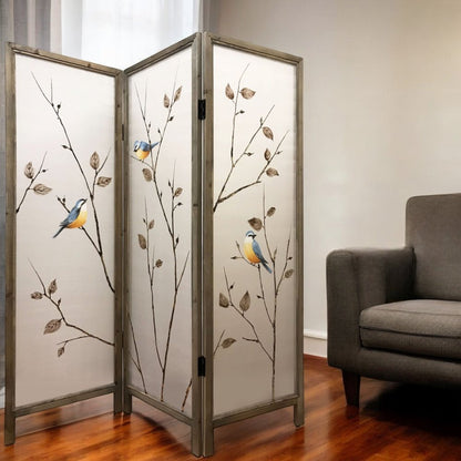 Three-panel decorative room divider with frosted glass, brown branches and blue-yellow birds, gray frame in living room.
