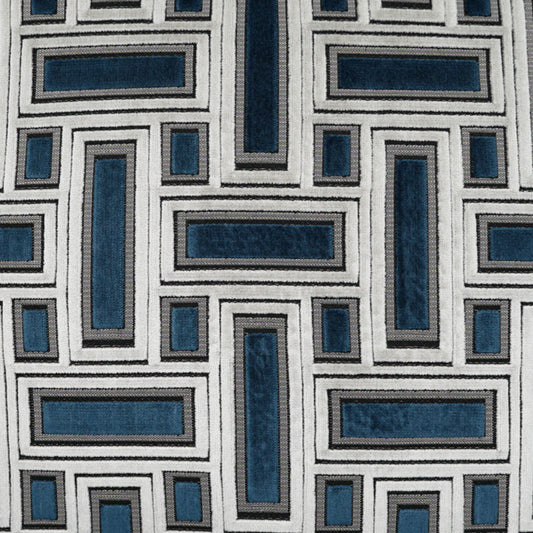 Geometric maze of interlocking cream and denim blue rectangles on fabric with textured borders.