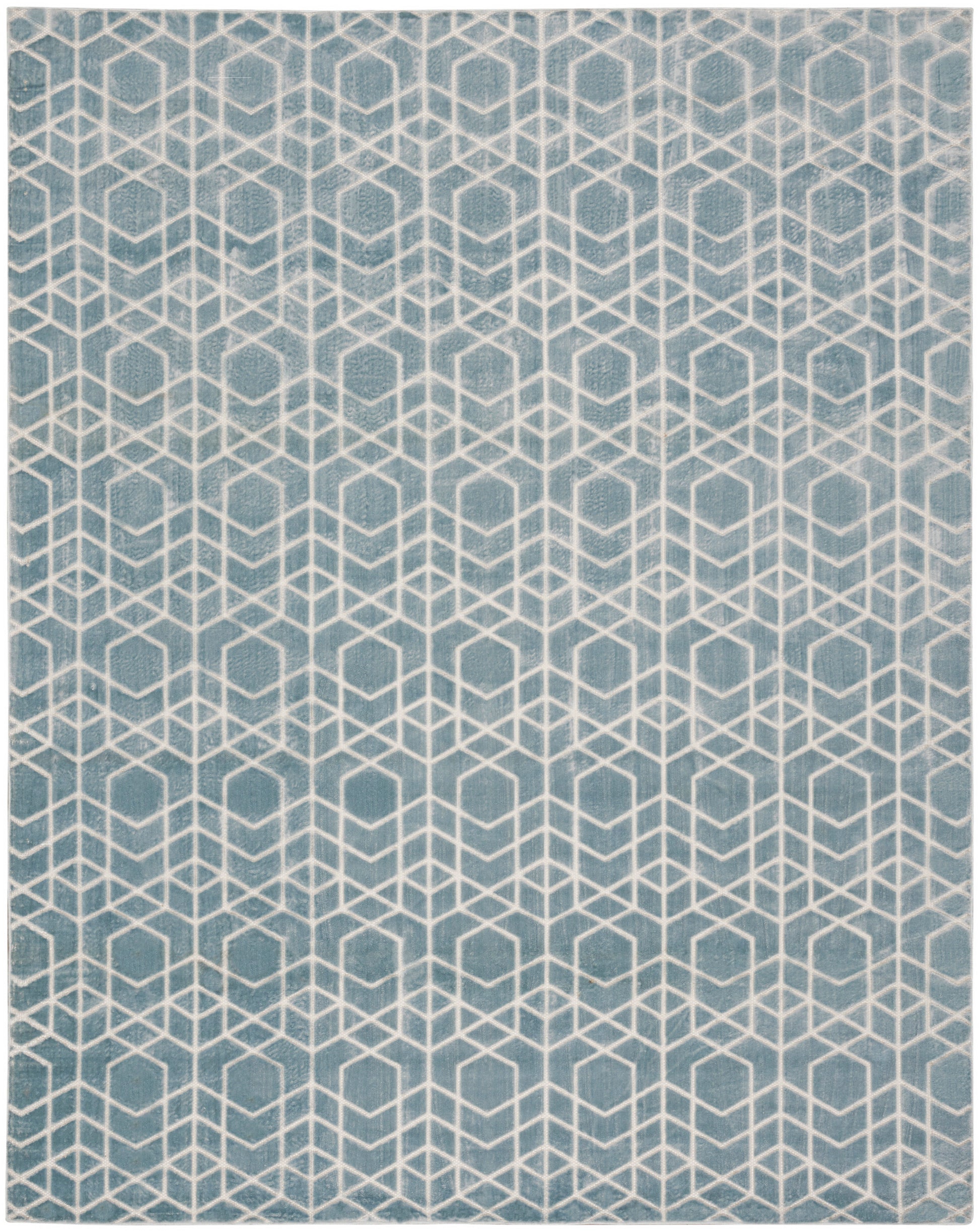 Teal rug with white geometric cube pattern, modern textured floor covering.