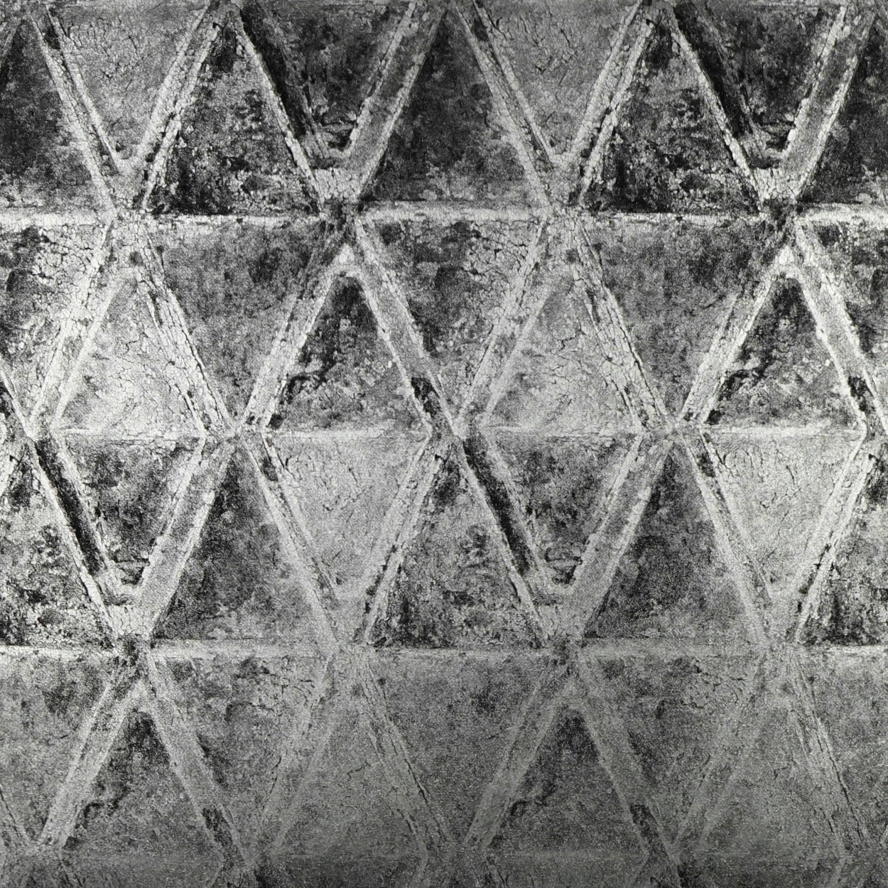 Grey fabric with a repeating embossed triangular pattern and a rugged textured surface.