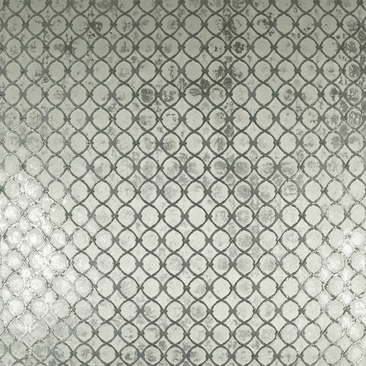 Grey metallic fabric with a repeating circular chain-link pattern; textured, modern upholstery material.