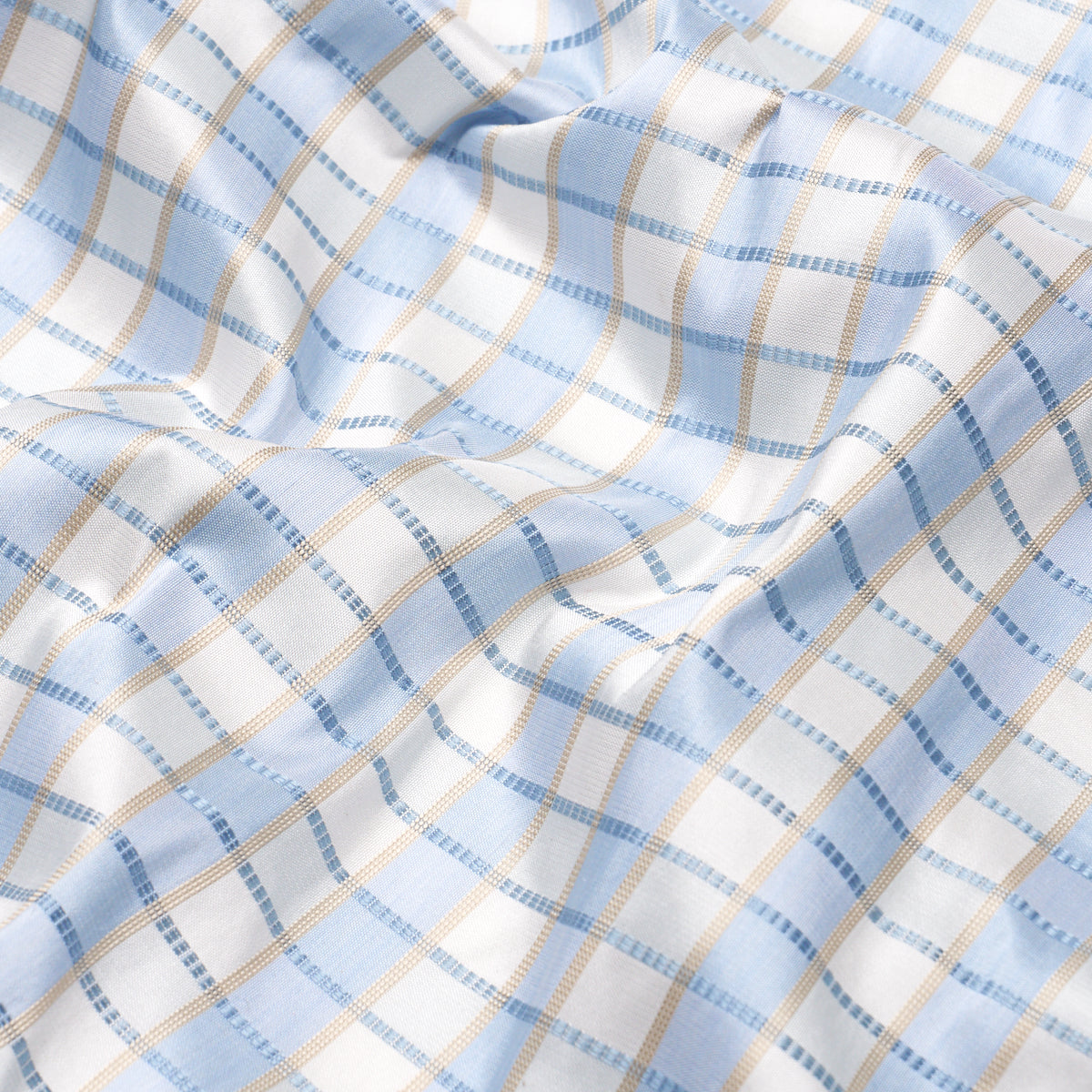 Light blue and white silk check fabric with beige lines, soft draped textile suitable for shirts or bedding.