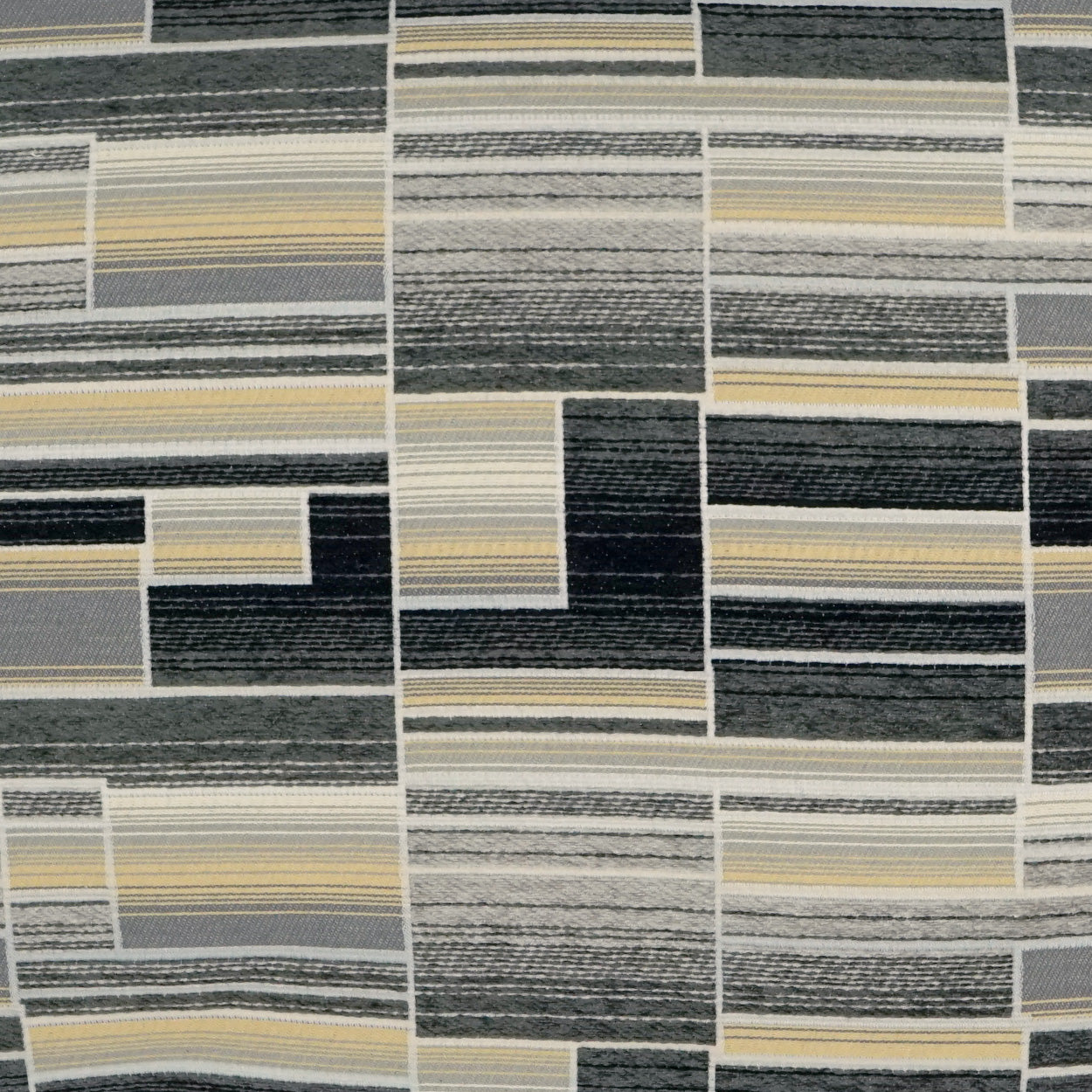 Patchwork fabric with rectangular blocks of striped gray, charcoal, navy, ivory & beige hues.