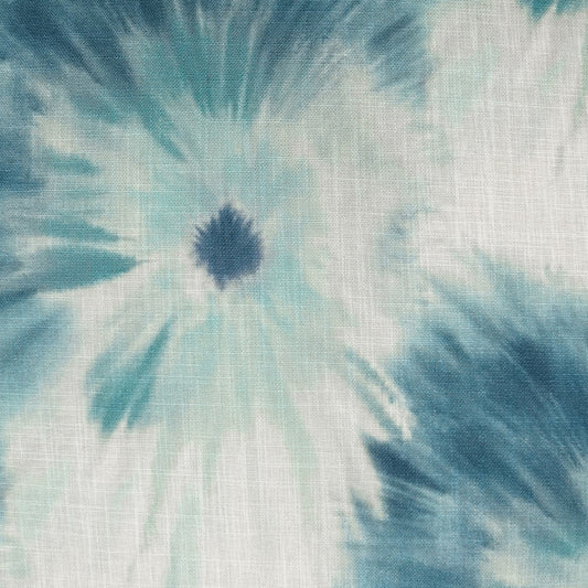 Teal and white tie-dye spiral on a woven fabric with a dark navy center; textured cotton-like material.