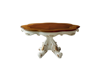 Ornate antique-style pedestal table with a cream carved base, gold detailing, and an oval natural wood top.