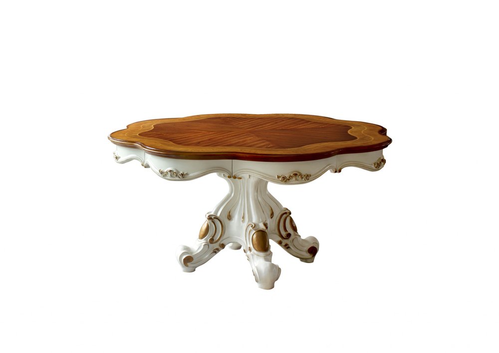 Ornate white and gold carved pedestal coffee table with an oval warm-wood top.
