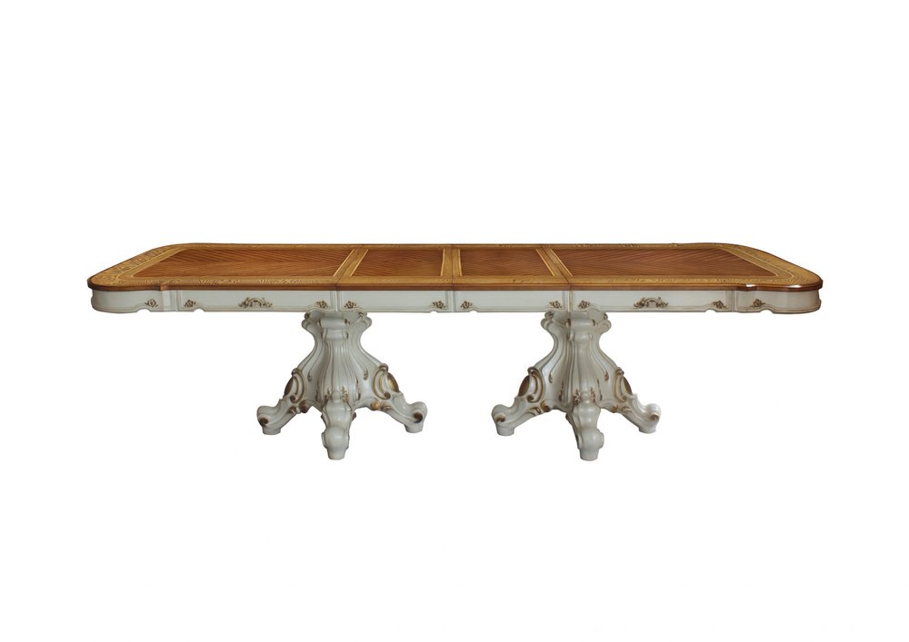 Antique-style rectangular solid wood dining table with parquet wood top and double, carved pedestals.