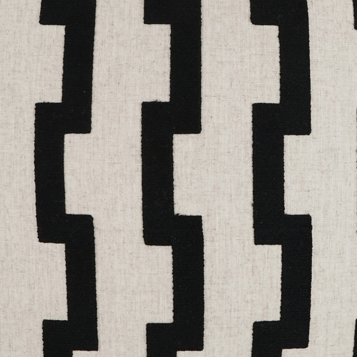 Beige woven fabric featuring a bold black stepped zigzag vertical pattern.
