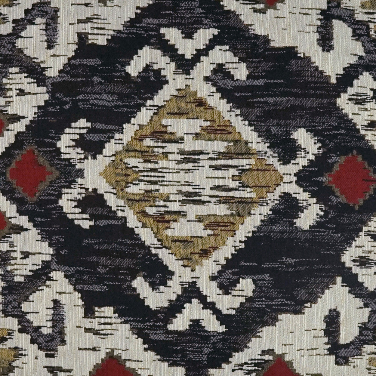 Woven geometric rug with cream background, navy lattice framing and tan diamond medallion, red accents.