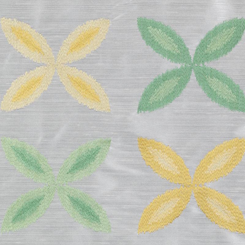 Grey textured fabric with pastel yellow and green four-petal floral motifs in a damask-style pattern.