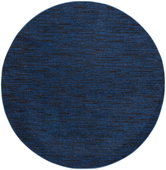 Round navy blue textured rug with subtle heather pattern, plush fabric ideal for living room floor.