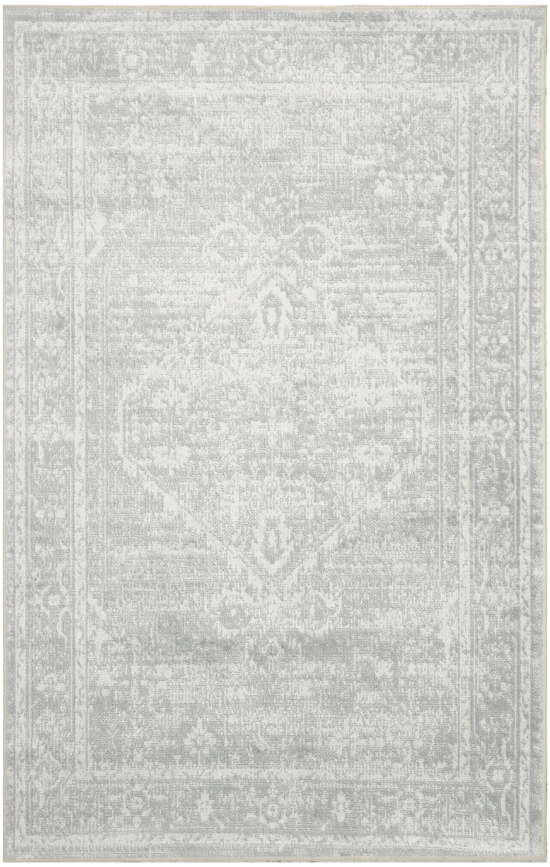 Light gray distressed rug with subtle Persian-inspired medallion and ornate border in vintage faded tones.