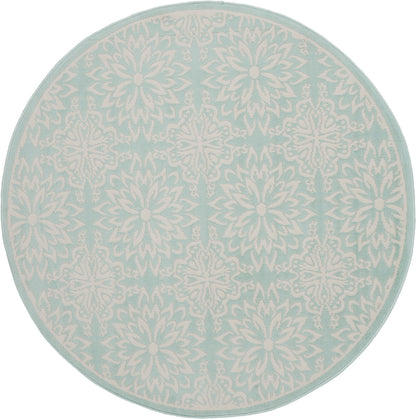 Round aqua rug with white intricate snowflake-mandala pattern and pale border.