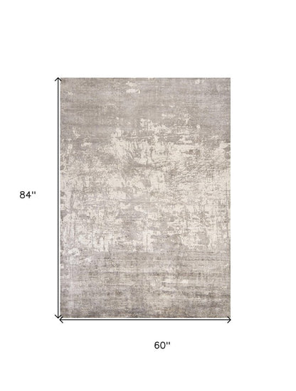 5' X 7' Beige And Ivory Abstract Hand Loomed Area Rug