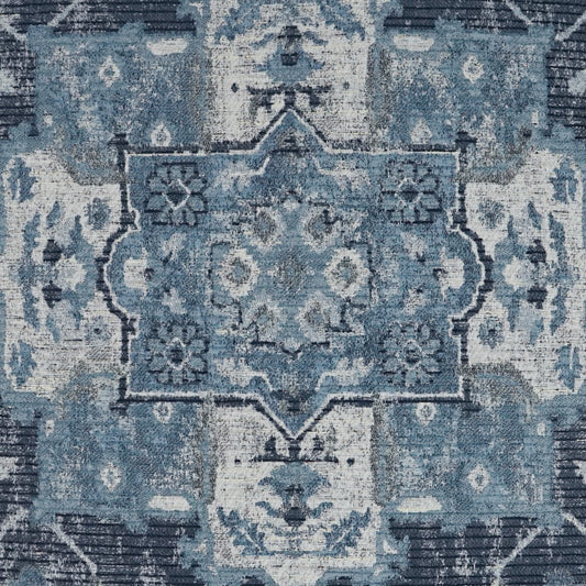Blue distressed oriental rug with central medallion, floral motifs and decorative border.