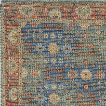 5' X 7' Blue Red And Beige Floral Medallion Hand Woven Distressed Area Rug