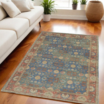 5' X 7' Blue Red And Beige Floral Medallion Hand Woven Distressed Area Rug