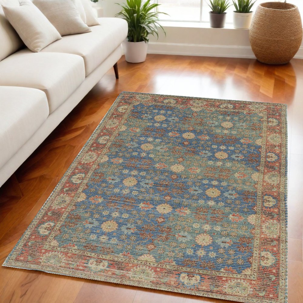 5' X 7' Blue Red And Beige Floral Medallion Hand Woven Distressed Area Rug