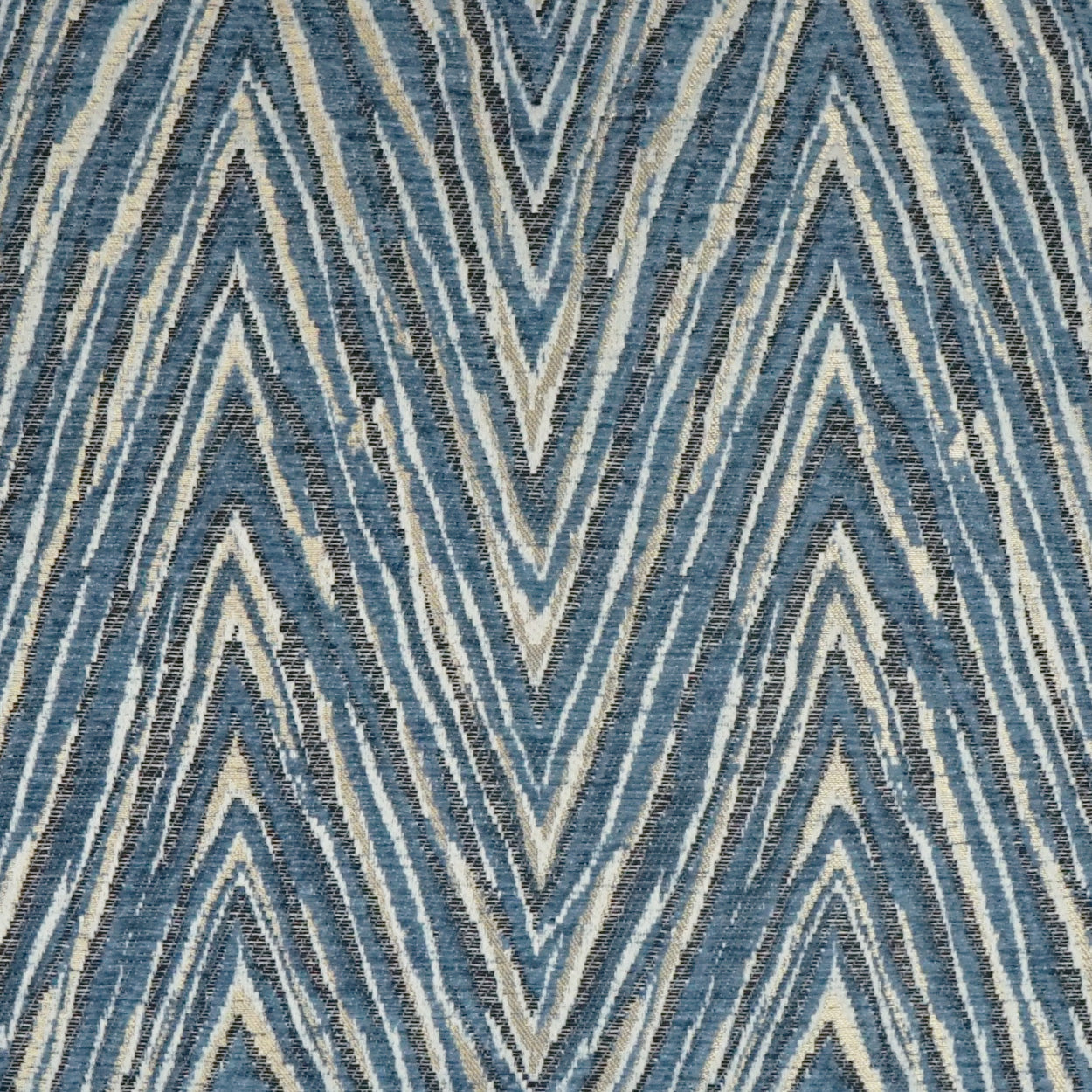 Blue chevron zigzag woven fabric in indigo and cream tones with a textured geometric pattern.