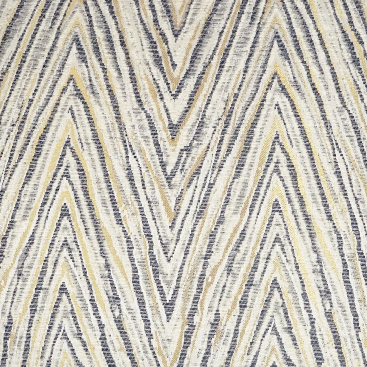 Chevron zigzag fabric in cream, navy, gray and tan; textured woven textile with bold chevron pattern.
