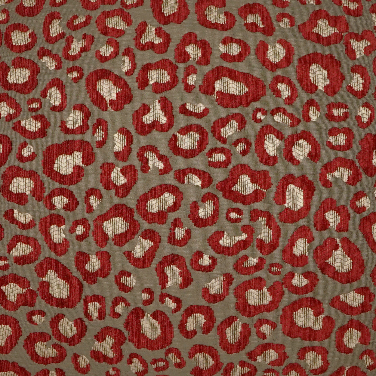 Red leopard print on taupe-gray fabric; irregular red spots with beige centers, woven textile style.