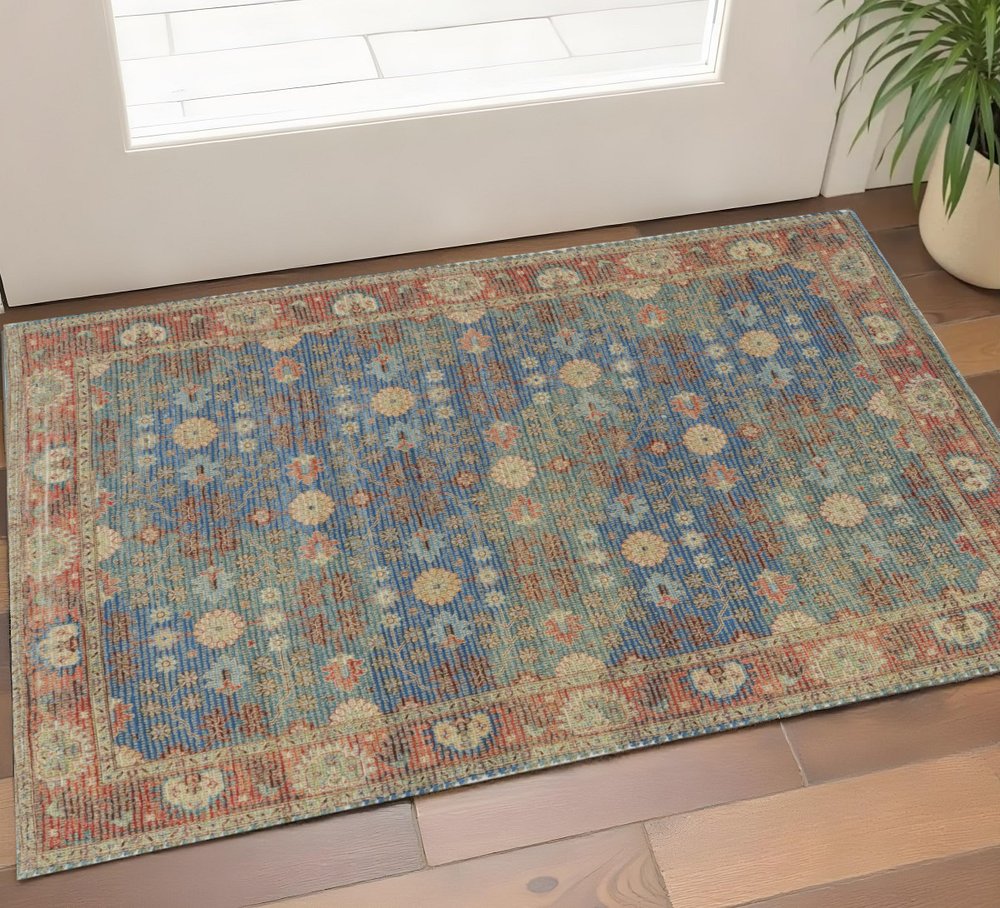 5' X 7' Blue Red And Beige Floral Medallion Hand Woven Distressed Area Rug