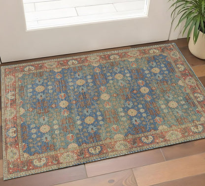 5' X 7' Blue Red And Beige Floral Medallion Hand Woven Distressed Area Rug