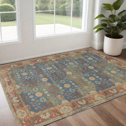 5' X 7' Blue Red And Beige Floral Medallion Hand Woven Distressed Area Rug