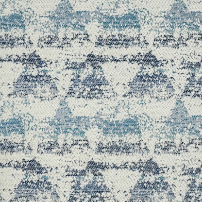 Cream fabric with blue, teal and navy geometric diamonds and zigzags; woven textile pattern on a 24" x 24" pillow.
